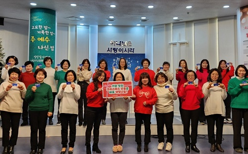 사진_생명나눔에 동참한 보배로운예수교회 성도들이 장기기증 희망등록증을 들고 있다..jpg